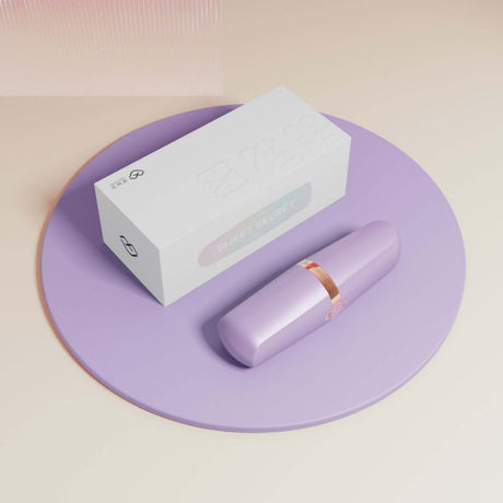 Sweet Secret Dual Massager Purple on a round purple surface with sleek packaging.
