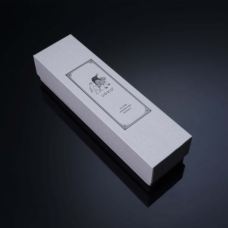Elegant white packaging box featuring artistic label design for luxury product presentation.