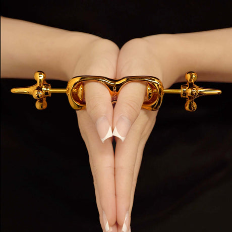UPKO Thumb Metal Cuffs showcasing a sleek design clasping fingers together for discipline play.