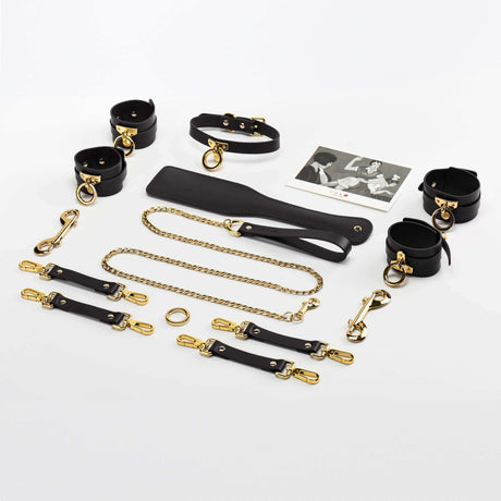 UPKO luxury Italian leather bondage tools set with gold accents, including collars, cuffs, leash, and accessories in a stylish arrangement.