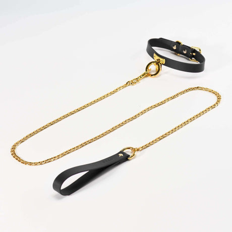 Black luxury leather collar and gold chain leash set for BDSM bondage play, elegant and stylish design for enhanced intimacy.