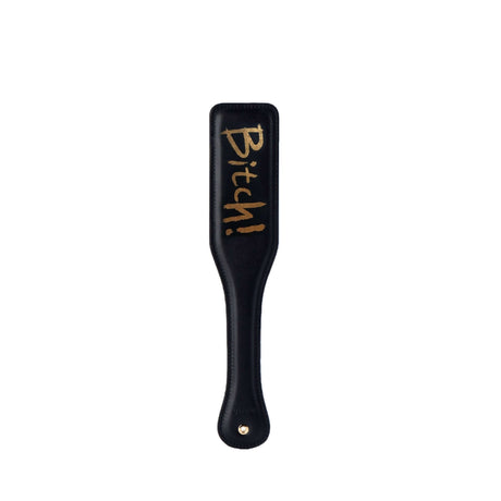Black leather paddle with “Bitch!” written in gold, ideal for BDSM and bondage play in luxurious style.