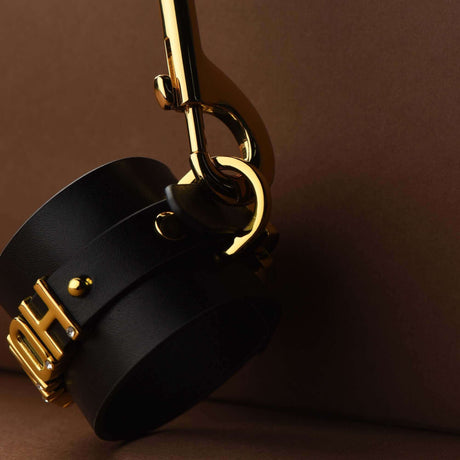 FUCK ME Luxury Italian Leather Handcuffs by UPKO showcasing elegant design with gold accents.