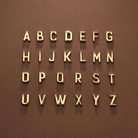 Alphabet letters A to Z in gold on a brown background, showcasing stylish typography design.