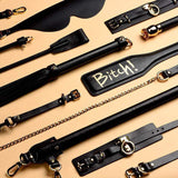 Assortment of luxury BDSM tools, including leather paddles and restraints, designed for high-end SM play.