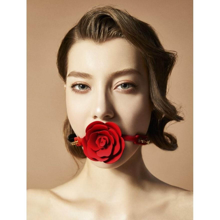 Woman wearing ZALO & UPKO Designer Collection Rose Ball Gag, featuring an elegant patented rose-shaped design for a sophisticated look.