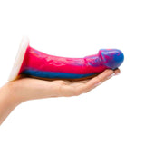 Vixen Mustang Realistic Dildo Tie Bright 7 inches held in a hand, showcasing its lifelike design and vibrant colors.